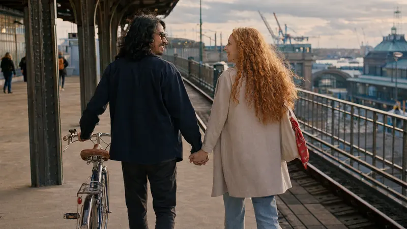 The same railway platform, the couple standing on it together.